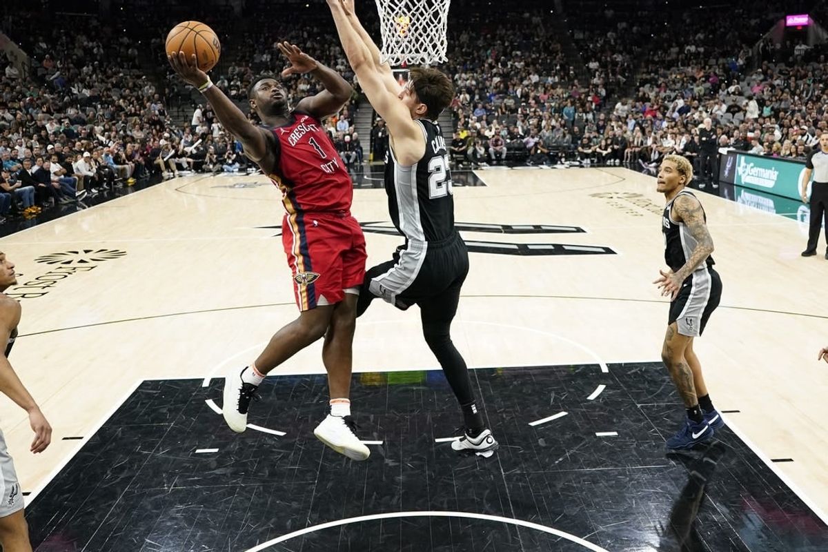 Feb 2, 2024; San Antonio, Texas, USA; New Orleans Pelicans forward Zion Williamson (1) shoots over San Antonio Spurs center Zach Collins (23) during the second half at Frost Bank Center.