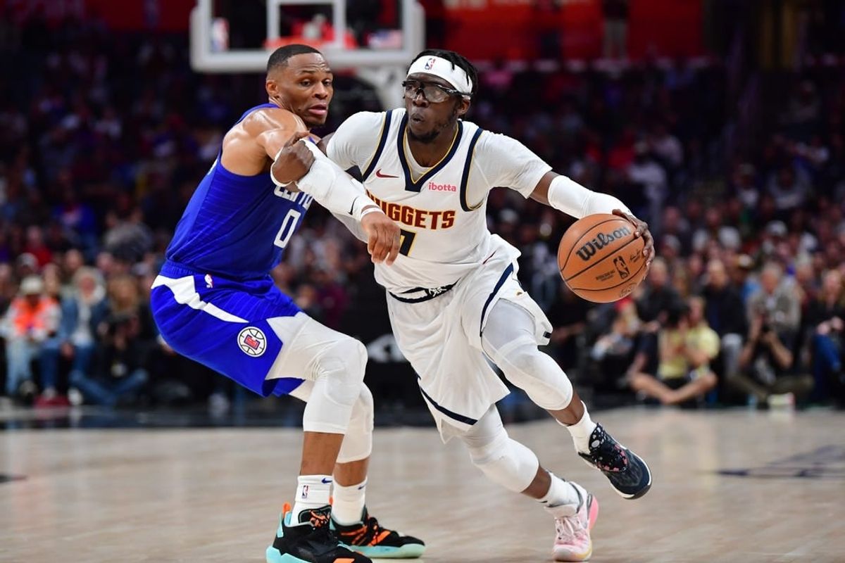 Nov 27, 2023; Los Angeles, California, USA; Denver Nuggets guard Reggie Jackson (7) moves the ball against Los Angeles Clippers guard Russell Westbrook (0) during the second half at Crypto.com Arena.