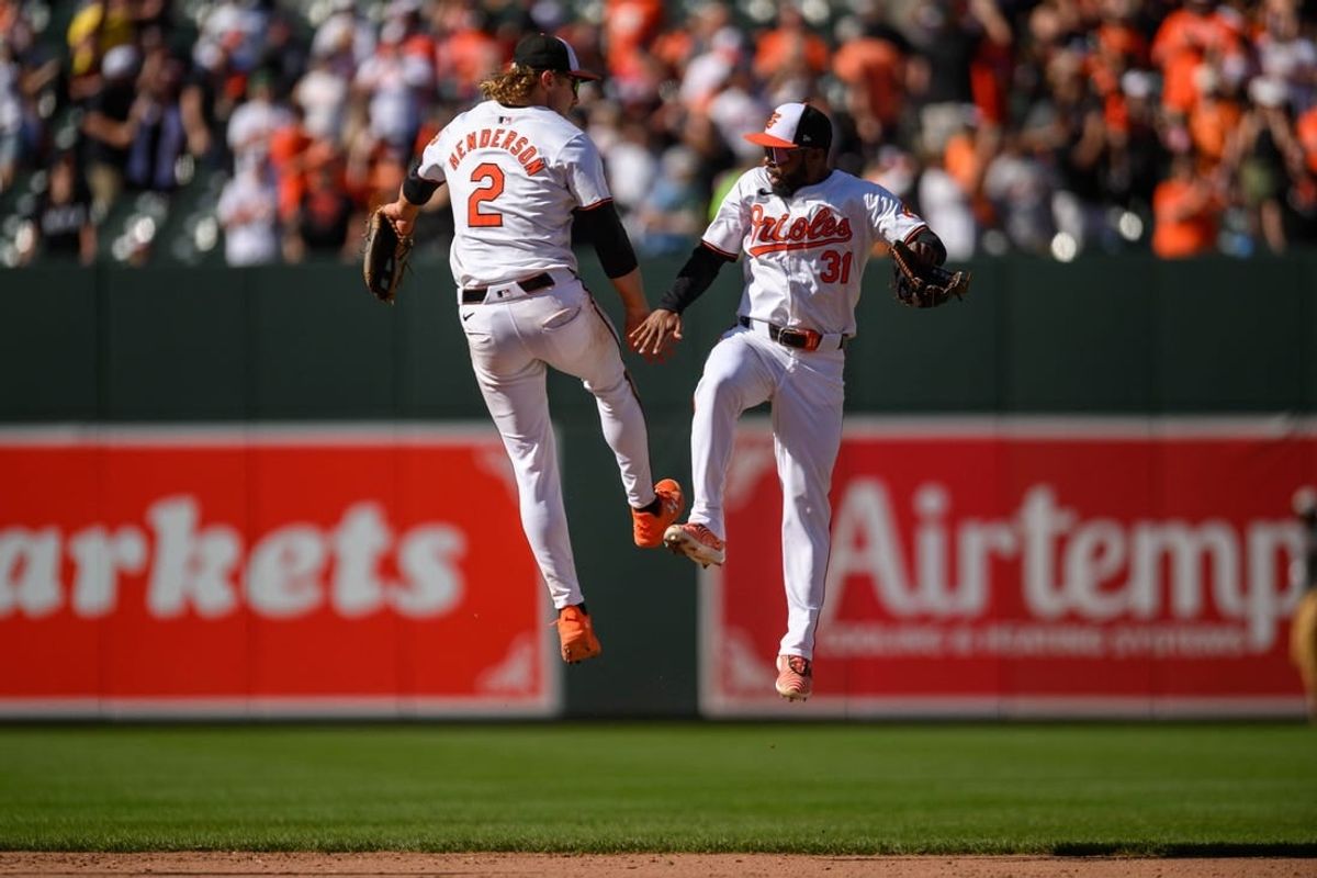 Apr 14, 2024; Baltimore, Maryland, USA; Baltimore Orioles shortstop Gunnar Henderson (2) and outfielder Cedric Mullins (31) celebrate after the game against the Milwaukee Brewers at Oriole Park at Camden Yards.