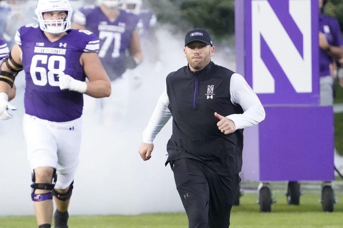 Sep 23, 2023; Evanston, Illinois, USA; Northwestern Wildcats head coach David Braun leads his team on the field before the game against the Minnesota Golden Gophers at Ryan Field.