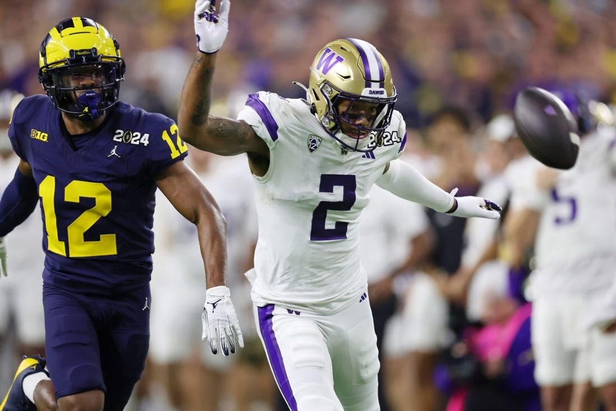 Jan 8, 2024; Houston, TX, USA; Michigan Wolverines defensive back Josh Wallace (12) and Washington Huskies wide receiver Ja'Lynn Polk (2) are unable to catch a pass during the third quarter in the 2024 College Football Playoff national championship game at NRG Stadium.