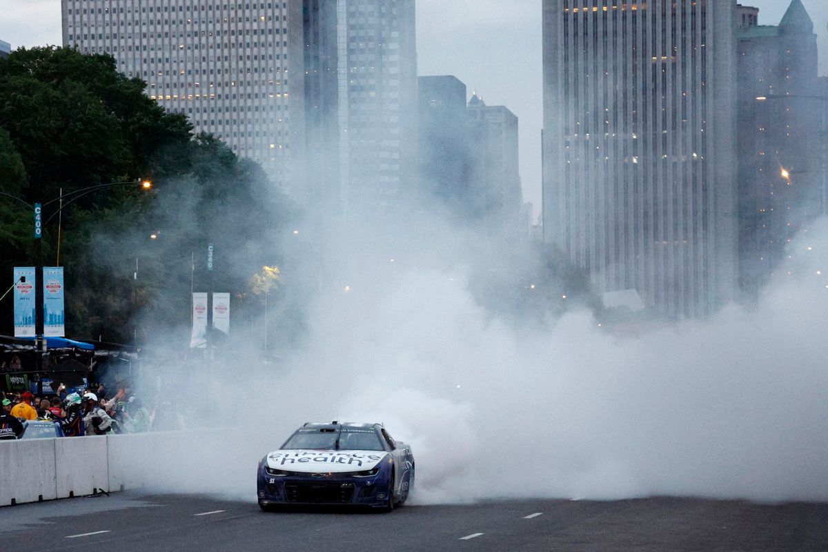 Shane Van Gisbergen celebrates with a burnout after winning the NASCAR Cup Series Grant Park 220 at the Chicago Street Course.