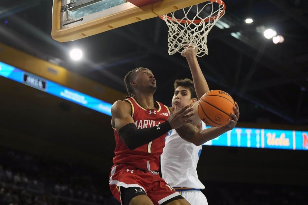 Dec 22, 2023; Los Angeles, California, USA; Maryland Terrapins guard Jahmir Young (1) shoots the ball against UCLA Bruins center Aday Mara (15) in the first half at Pauley Pavilion presented by Wescom.