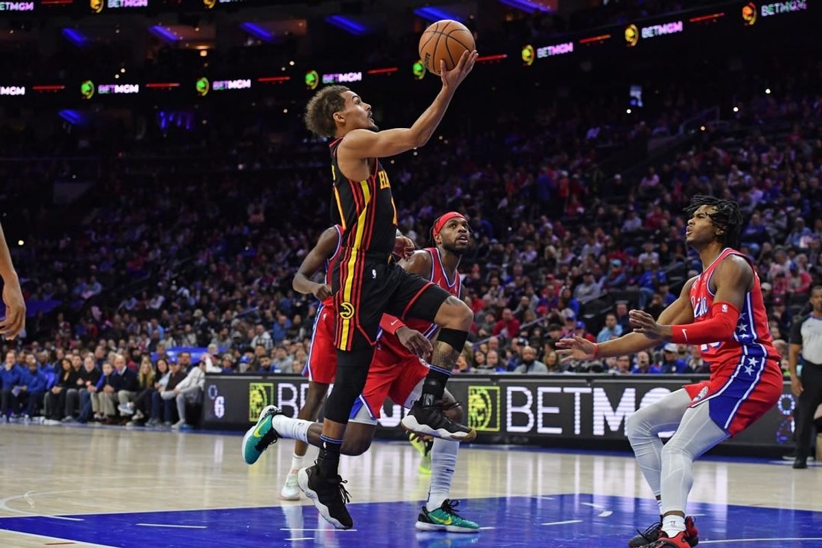 Feb 9, 2024; Philadelphia, Pennsylvania, USA; Atlanta Hawks guard Trae Young (11) drives to the basket past Philadelphia 76ers guard Buddy Hield (17) during the second quarter at Wells Fargo Center.
