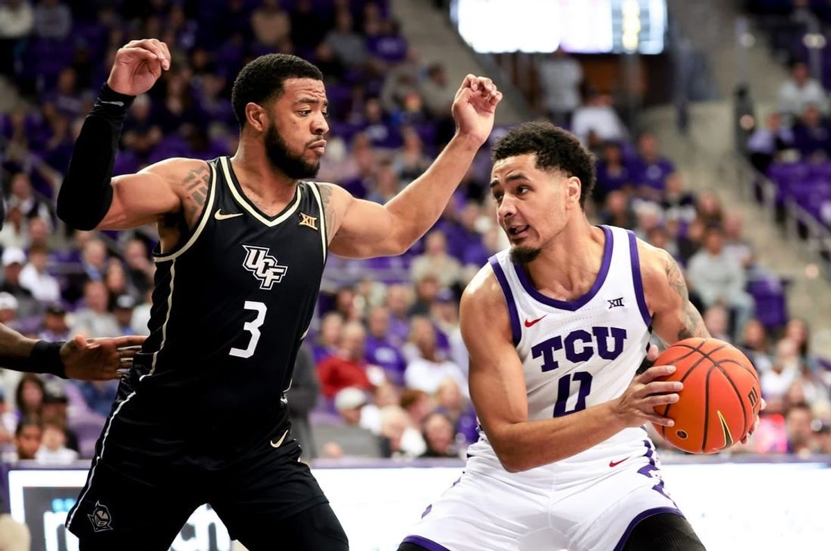 Mar 9, 2024; Fort Worth, Texas, USA;  TCU Horned Frogs guard Micah Peavy (0) controls the ball as UCF Knights guard Darius Johnson (3) defends during the first half at Ed and Rae Schollmaier Arena.