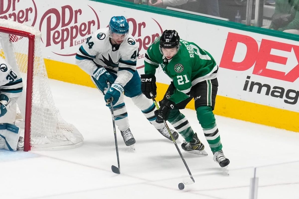 Mar 2, 2024; Dallas, Texas, USA;  Dallas Stars left wing Jason Robertson (21) skates with the puck as San Jose Sharks defenseman Marc-Edouard Vlasic (44) defends during the third period at American Airlines Center.