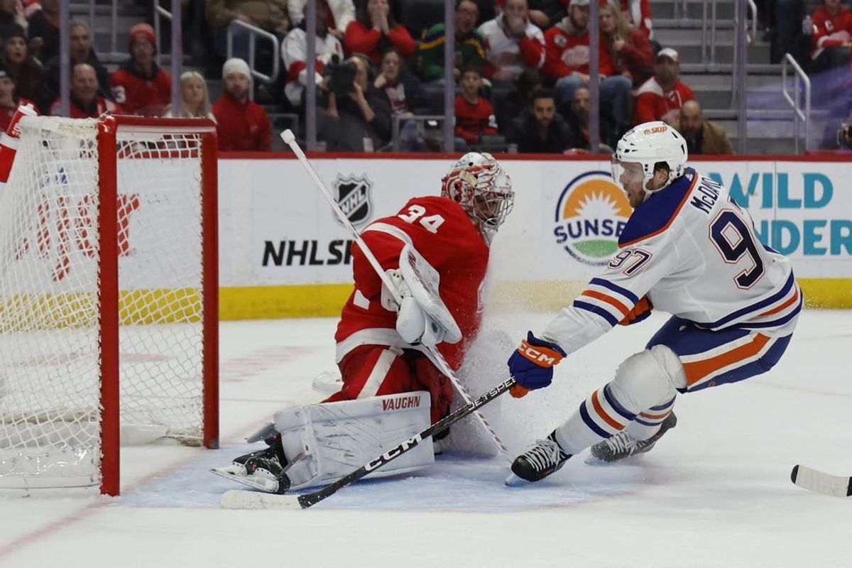 Jan 11, 2024; Detroit, Michigan, USA;  Edmonton Oilers center Connor McDavid (97) scores on Detroit Red Wings goaltender Alex Lyon (34) in the third period at Little Caesars Arena.