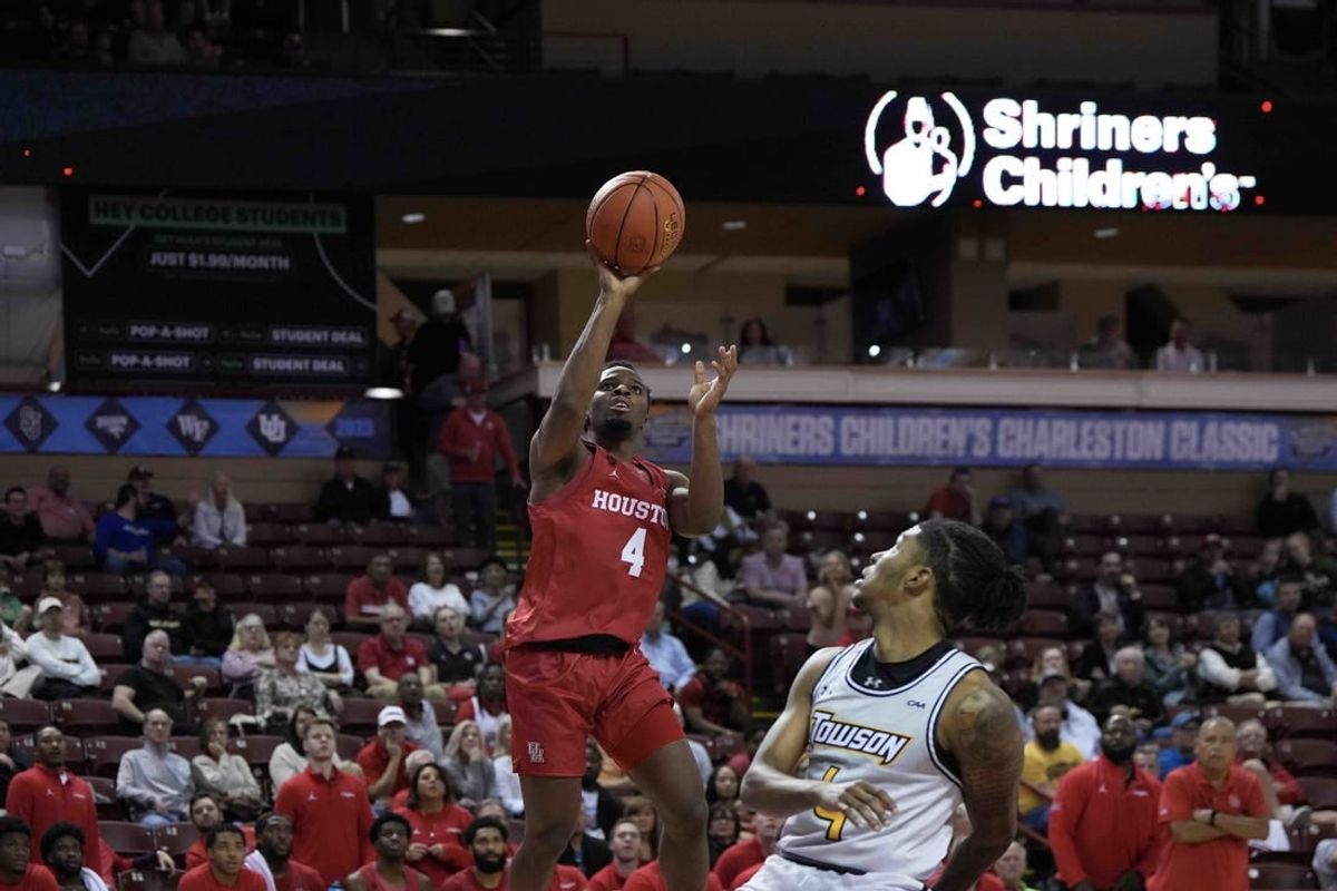 Nov 16, 2023; Charleston, South Carolina, USA; Houston Cougars guard LJ Cryer (4) shoots the ball over Towson Tigers guard Dylan Williamson (4) in the second half at TD Arena.