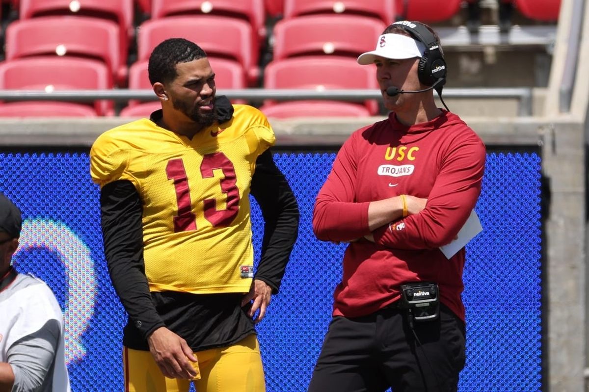 USC Trojans quarterback Caleb Williams (13) and head coach Lincoln Riley watch the game from the sideline during the Spring Game at Los Angeles Memorial Coliseum.