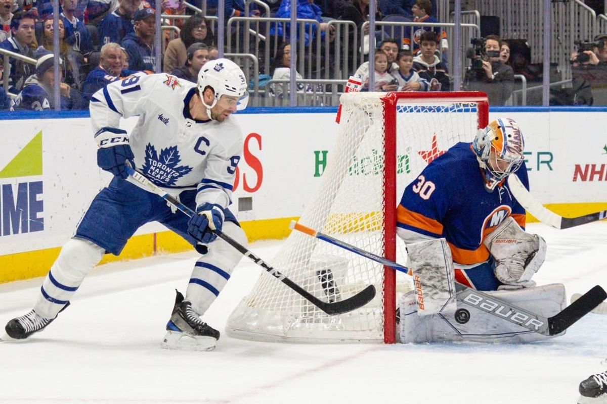 Dec 11, 2023; Elmont, New York, USA; Toronto Maple Leafs center John Tavares (91) takes a shot while New York Islanders goaltender Ilya Sorokin (30) makes the save during the third period at UBS Arena.
