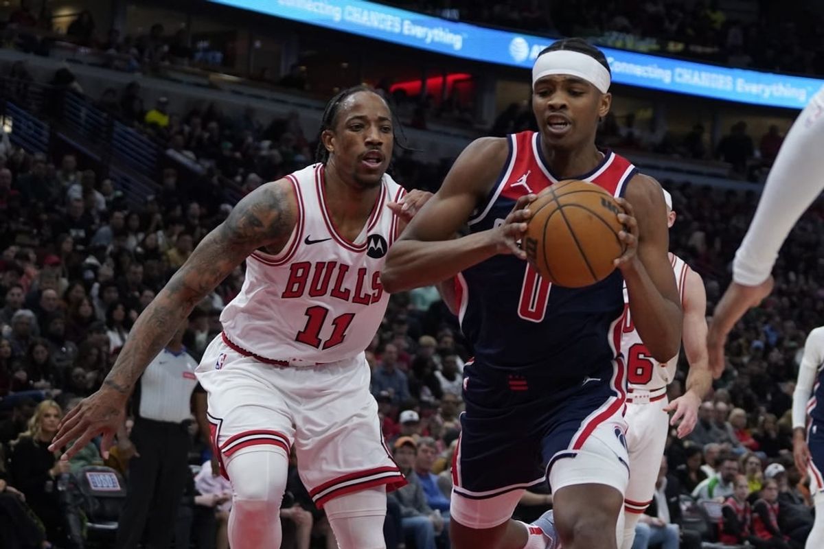 Mar 16, 2024; Chicago, Illinois, USA; Chicago Bulls forward DeMar DeRozan (11) defends Washington Wizards guard Bilal Coulibaly (0) during the second half at United Center.