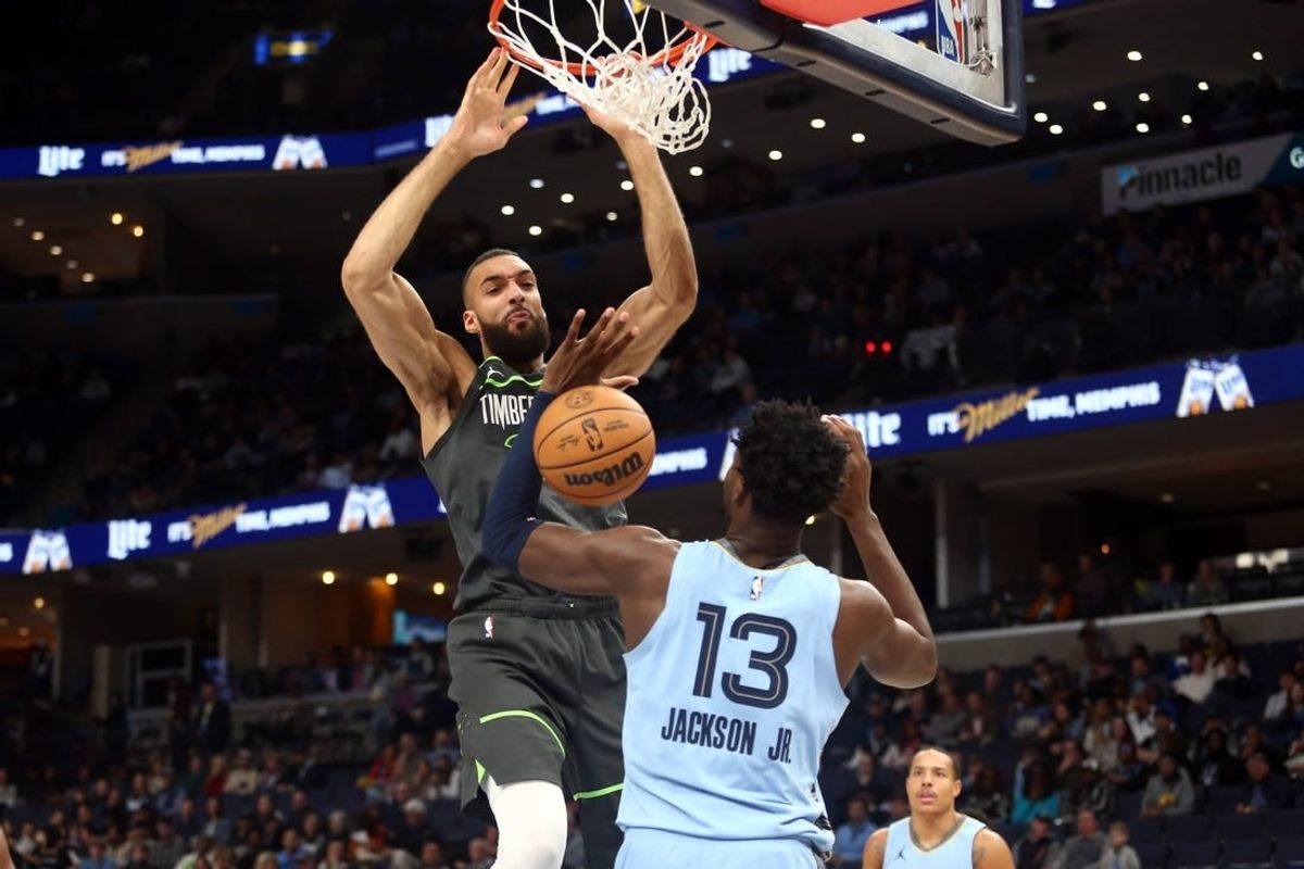 Nov 24, 2023; Memphis, Tennessee, USA; Minnesota Timberwolves center Rudy Gobert (27) dunks over Memphis Grizzlies forward-center Jaren Jackson Jr. (13) during the first half at FedExForum.