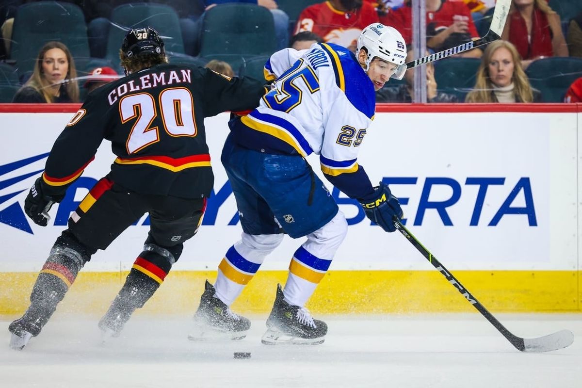 Jan 23, 2024; Calgary, Alberta, CAN; St. Louis Blues center Jordan Kyrou (25) controls the puck against Calgary Flames center Blake Coleman (20) during the first period at Scotiabank Saddledome.
