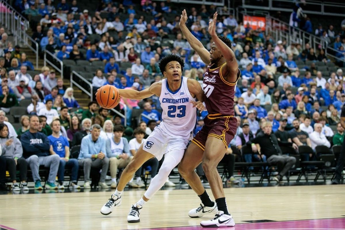 Nov 22, 2023; Kansas City, Missouri, USA; Creighton Bluejays guard Trey Alexander (23) drives around Loyola (Il) Ramblers forward Patrick Mwamba (30) during the first half at T-Mobile Center.