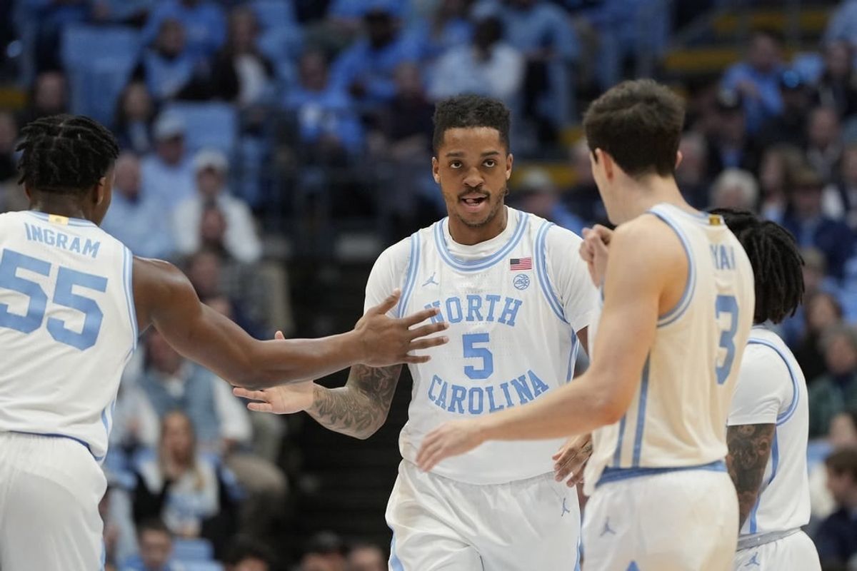 Jan 13, 2024; Chapel Hill, North Carolina, USA; North Carolina Tar Heels forward Armando Bacot (5) reacts with forward Harrison Ingram (55) and guard Cormac Ryan (3) in the first half at Dean E. Smith Center.
