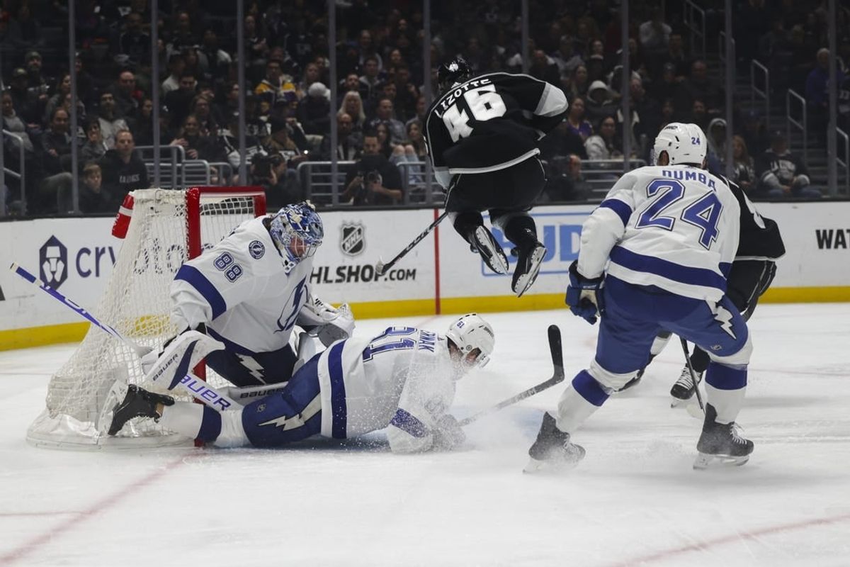 Mar 23, 2024; Los Angeles, California, USA; Los Angeles Kings center Blake Lizotte (46) leaps over Tampa Bay Lighting defensemen Erik Cernak (81) during the second period of an NHL hockey game at Crypto.com Arena.