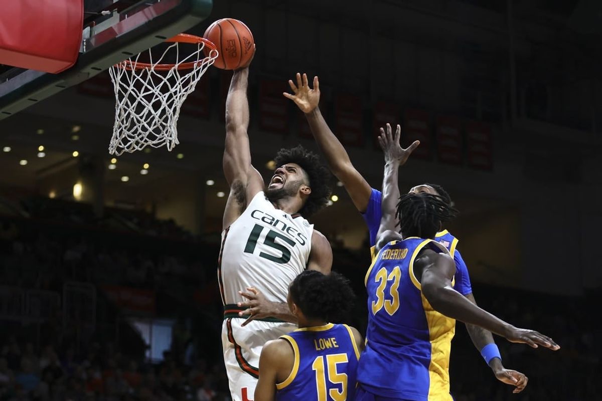 Jan 27, 2024; Coral Gables, Florida, USA; Miami Hurricanes forward Norchad Omier (15) dunks the basketball against Pittsburgh Panthers guard Jaland Lowe (15), center Federiko Federiko (33) and forward Zack Austin (55) during the second half at Watsco Center.