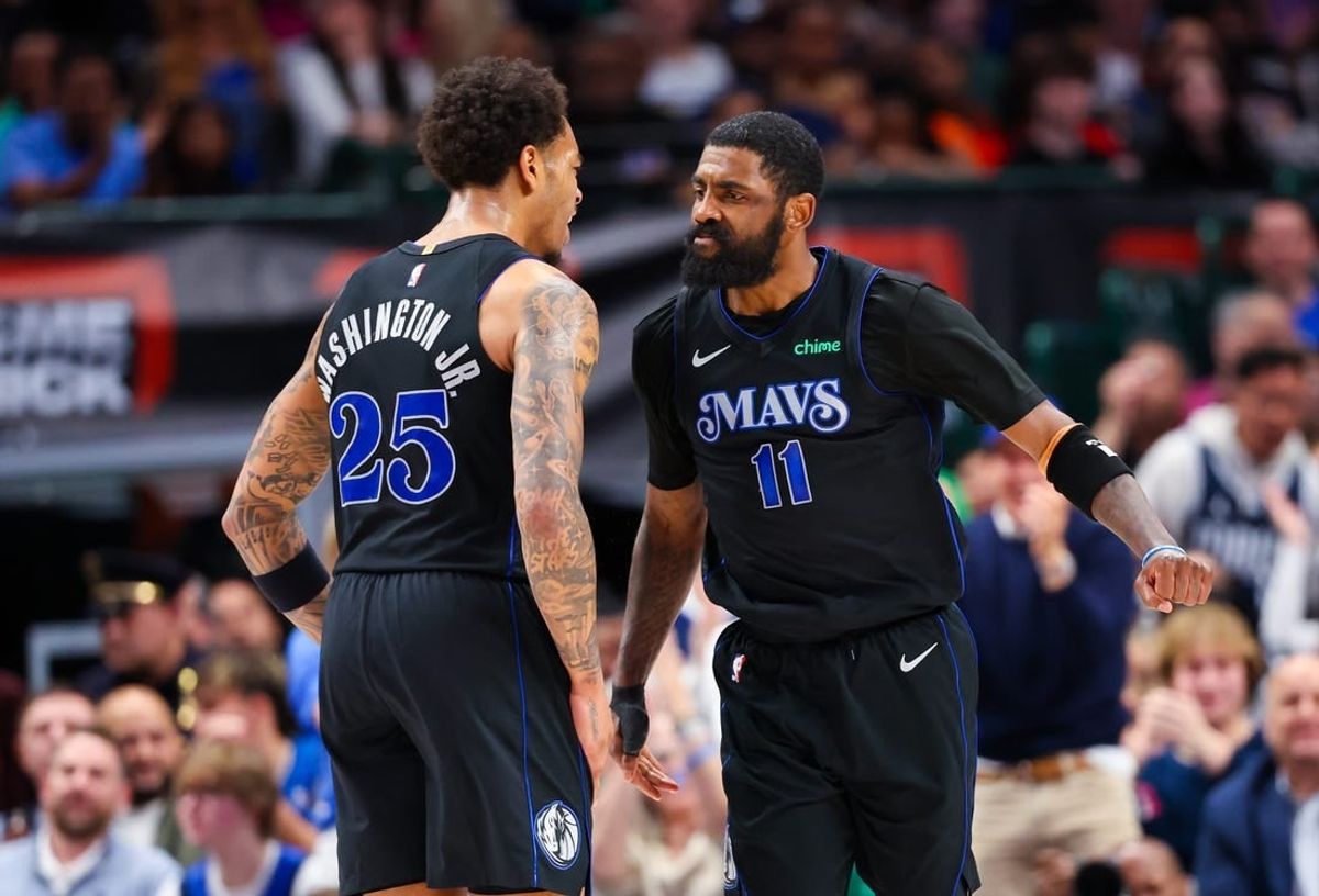 Feb 22, 2024; Dallas, Texas, USA;  Dallas Mavericks guard Kyrie Irving (11) celebrates with Dallas Mavericks forward P.J. Washington (25) during the second half against the Phoenix Suns at American Airlines Center.