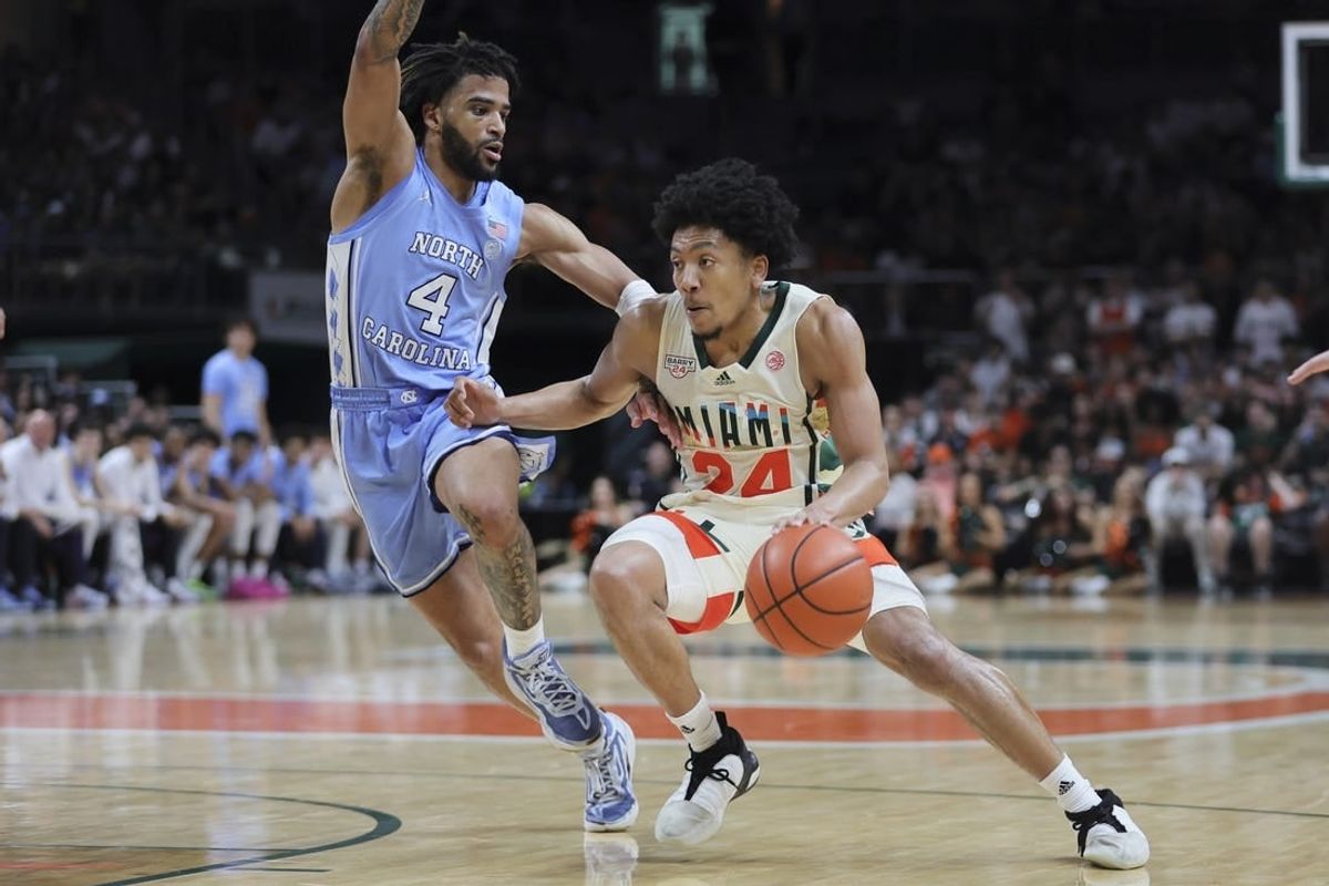 Feb 10, 2024; Coral Gables, Florida, USA; Miami Hurricanes guard Nijel Pack (24) drives to the basket past North Carolina Tar Heels guard RJ Davis (4) during the second half at Watsco Center.