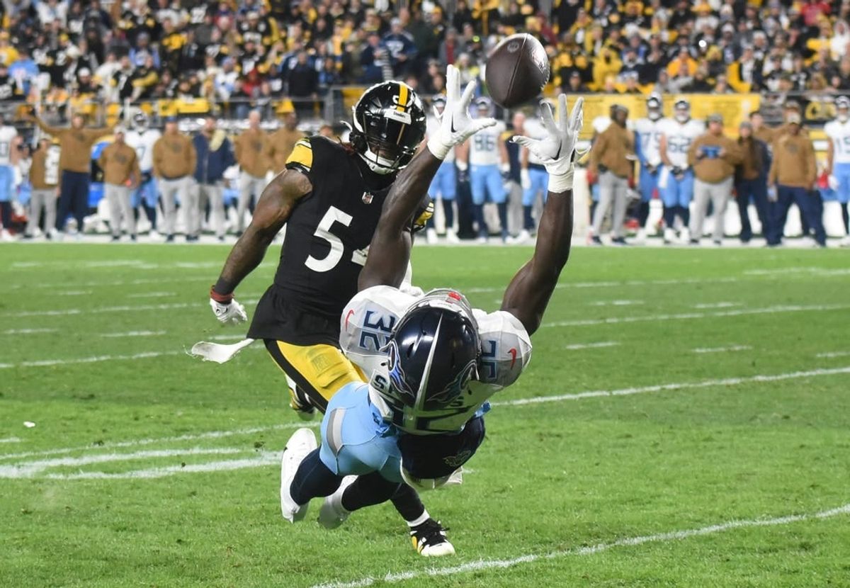 Nov 2, 2023; Pittsburgh, Pennsylvania, USA; The ball goes through hands of Tennessee Titans running back Tyjae Spears (32) as Pittsburgh Steelers linebacker Kwon Alexander (54) applies coverage during the second quarter at Acrisure Stadium.