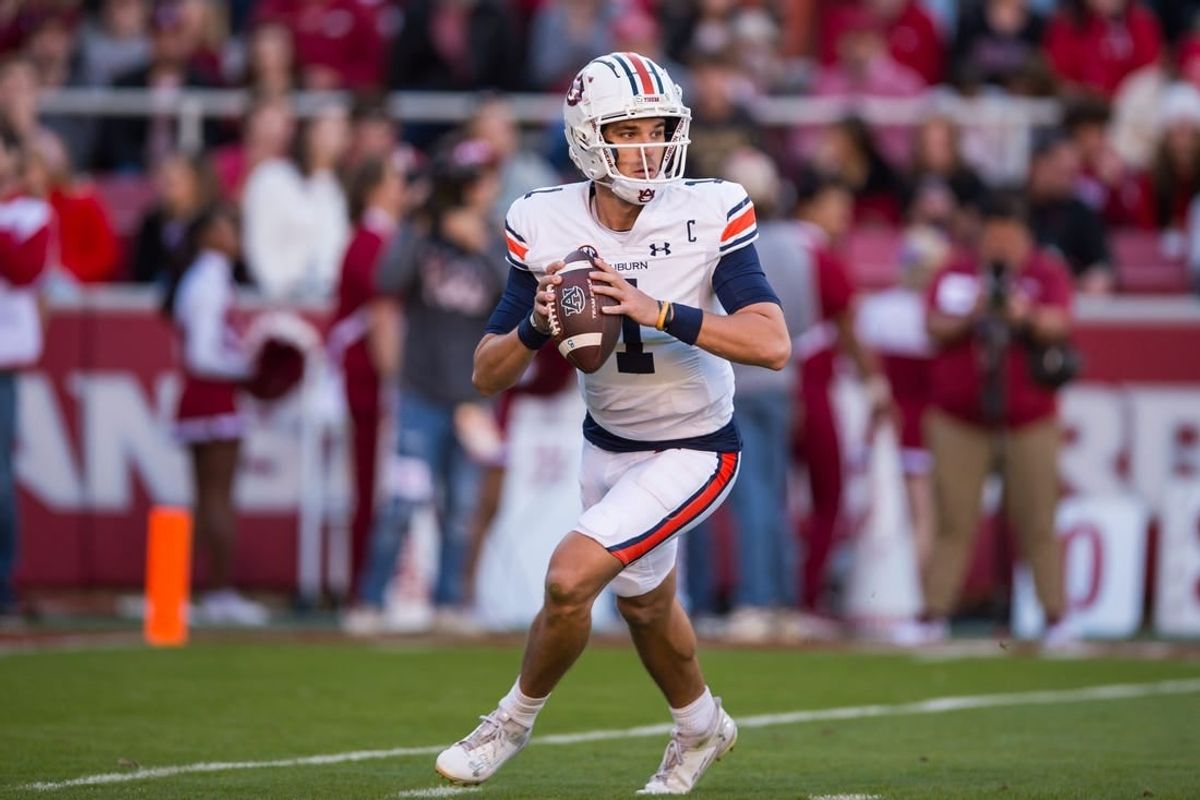 Nov 11, 2023; Fayetteville, Arkansas, USA;  Auburn Tigers quarterback Payton Thorne (1) rolls out to pass during the second quarter against the Arkansas Razorbacks at Donald W. Reynolds Razorback Stadium.