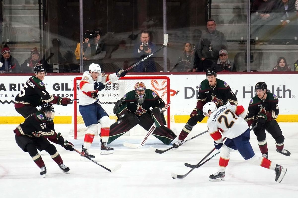 Jan 2, 2024; Tempe, Arizona, USA; Florida Panthers center Eetu Luostarinen (27) shoots against Arizona Coyotes goaltender Karel Vejmelka (70) during the second period at Mullett Arena.