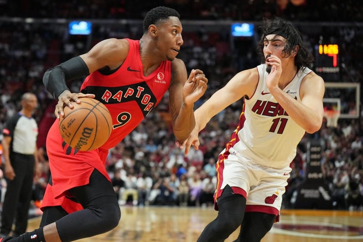 Apr 12, 2024; Miami, Florida, USA;  Toronto Raptors guard RJ Barrett (9) drives toward the basket as Miami Heat guard Jaime Jaquez Jr. (11) defends during the second half at Kaseya Center.