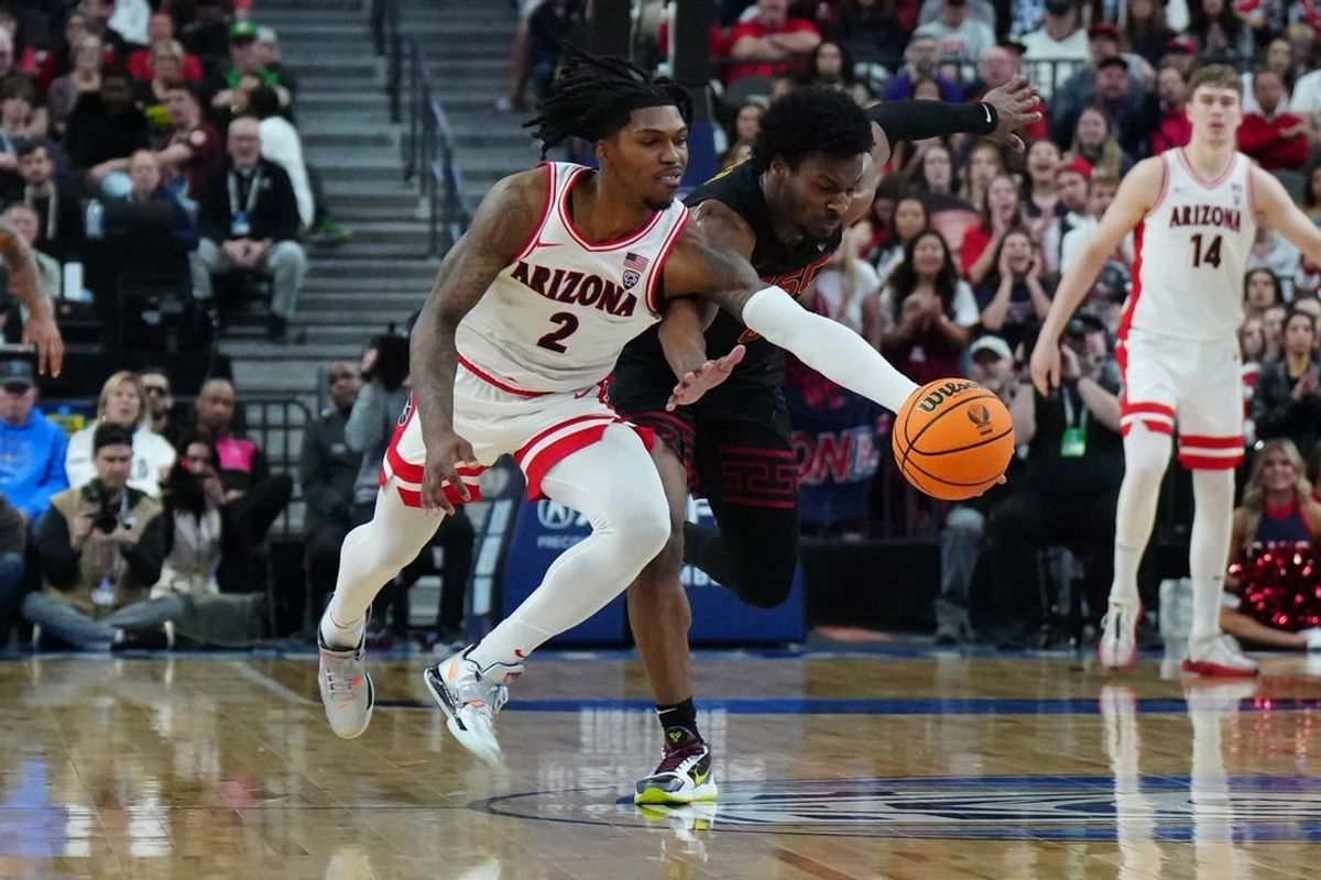 Mar 14, 2024; Las Vegas, NV, USA; Arizona Wildcats guard Caleb Love (2) and Southern California Trojans guard Bronny James (6) battle for the ball in the first half at T-Mobile Arena.
