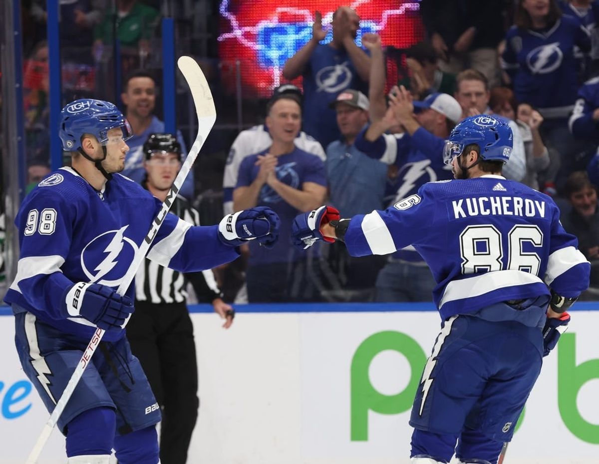Dec 4, 2023; Tampa, Florida, USA; Tampa Bay Lightning right wing Nikita Kucherov (86) celebrates with  defenseman Mikhail Sergachev (98) after he scores a goal against the Dallas Stars during the first period at Amalie Arena.