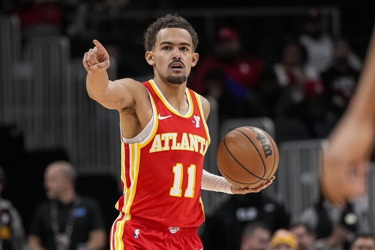 Jan 28, 2024; Atlanta, Georgia, USA; Atlanta Hawks guard Trae Young (11) points to a teammate against the Toronto Raptors during the first half at State Farm Arena.