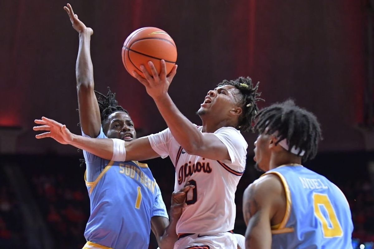 Nov 19, 2023; Champaign, Illinois, USA;  Illinois Fighting Illini guard Terrence Shannon Jr. (0) drives to the basket as Southern Jaguars forward JaRonn Wilkens (1) defends during the first half at State Farm Center.