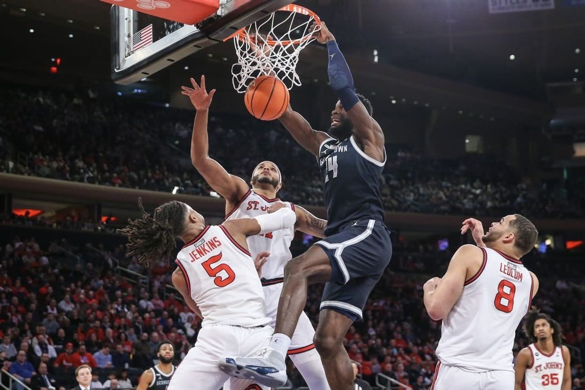 Mar 9, 2024; New York, New York, USA;  Georgetown Hoyas forward Supreme Cook (24) dunks past St. John's Red Storm guard Daniss Jenkins (5) in the first half at Madison Square Garden.