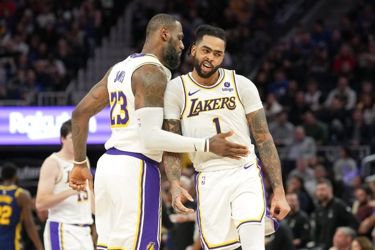 Jan 27, 2024; San Francisco, California, USA; Los Angeles Lakers forward LeBron James (23) celebrates with guard D'Angelo Russell (1) during the second overtime against the Golden State Warriors at Chase Center.