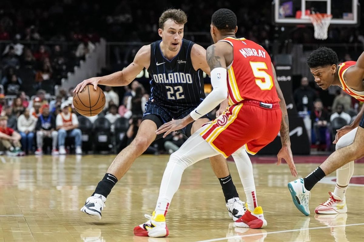 Feb 25, 2024; Atlanta, Georgia, USA; Orlando Magic forward Franz Wagner (22) dribbles against Atlanta Hawks guard Dejounte Murray (5) during the first half at State Farm Arena.