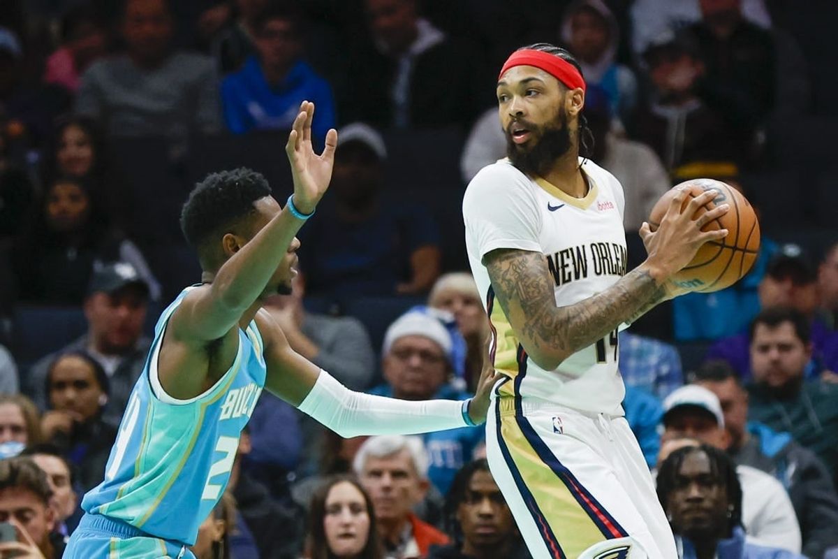 Dec 15, 2023; Charlotte, North Carolina, USA; New Orleans Pelicans forward Brandon Ingram (14) looks to pass over Charlotte Hornets forward Brandon Miller (24) during the first quarter at Spectrum Center.