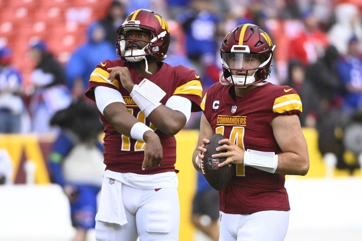 Sep 24, 2023; Landover, Maryland, USA; Washington Commanders quarterback Sam Howell (14) and quarterback Jacoby Brissett (12) on the field before the game against the Buffalo Bills at FedExField.
