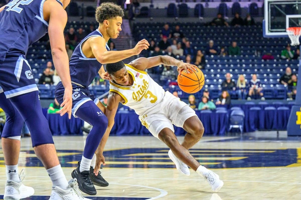 Dec 19, 2023; South Bend, Indiana, USA; Notre Dame Fighting Irish guard Markus Burton (3) loses his footing as Citadel Bulldogs guard Elijah Morgan (4) defends in the first half at the Purcell Pavilion.
