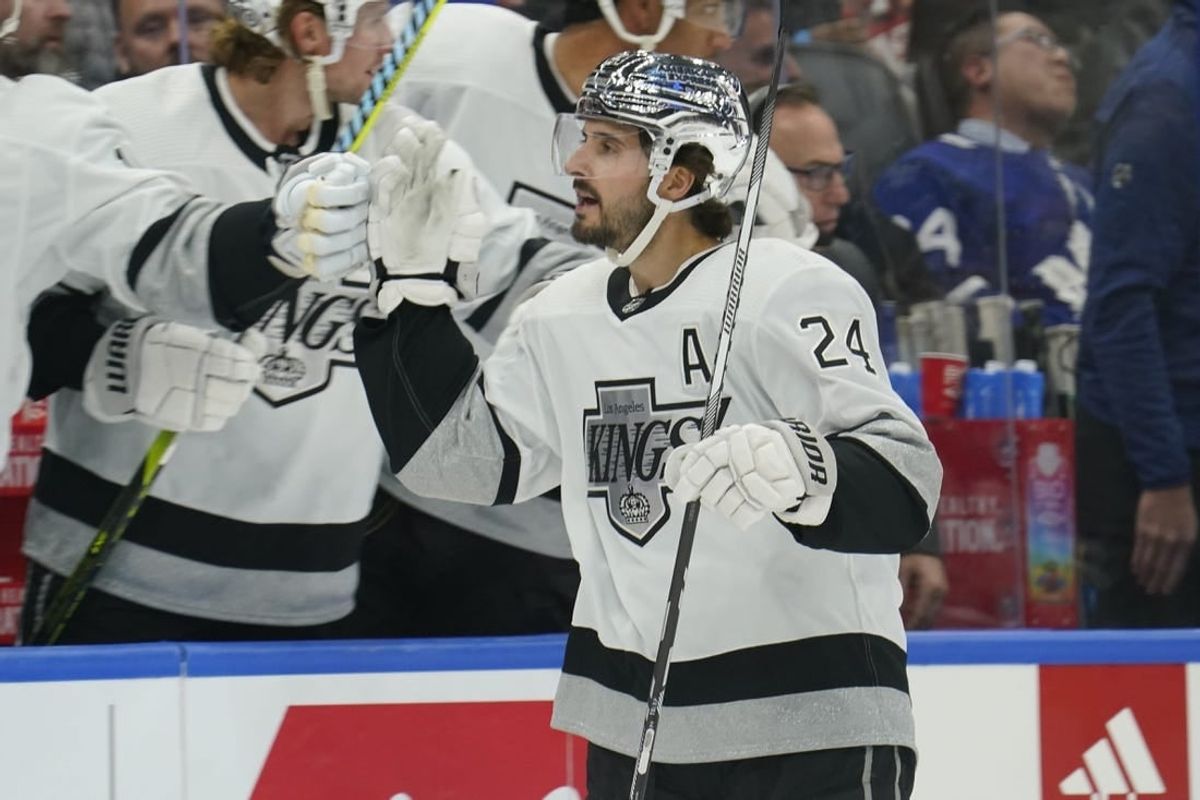 Oct 31, 2023; Toronto, Ontario, CAN; Los Angeles  Kings forward Phillip Danault (24) gets congratulated after scoring against the Toronto Maple Leafs during the first period at Scotiabank Arena.