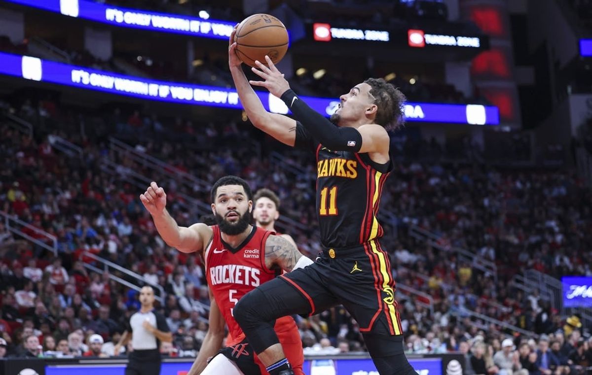 Dec 20, 2023; Houston, Texas, USA; Atlanta Hawks guard Trae Young (11) drives with the ball on a fast break as Houston Rockets guard Fred VanVleet (5) defends during the fourth quarter at Toyota Center.