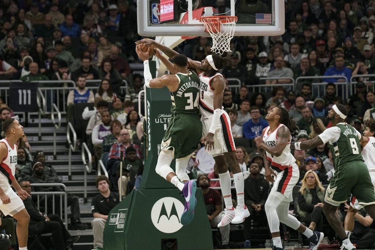Nov 26, 2023; Milwaukee, Wisconsin, USA;  Portland Trail Blazers forward Jerami Grant (9) defends Milwaukee Bucks forward Giannis Antetokounmpo (34) during the fourth quarter at Fiserv Forum.