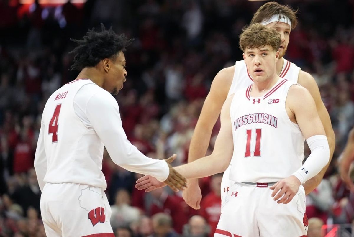 Jan 19, 2024; Madison, Wisconsin, USA; Wisconsin Badgers guard Max Klesmit (11) celebrates a three point basket with Wisconsin Badgers guard Kamari McGee (4) during the second half against the Indiana Hoosiers at the Kohl Center.