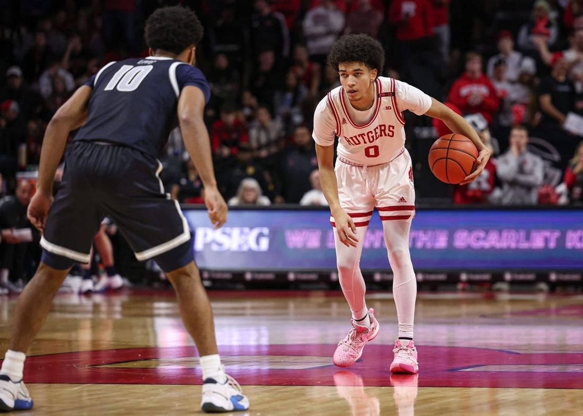 Nov 15, 2023; Piscataway, New Jersey, USA; Rutgers Scarlet Knights guard Derek Simpson (0) dribbles as Georgetown Hoyas guard Jayden Epps (10) defends during the second half at Jersey Mike's Arena.