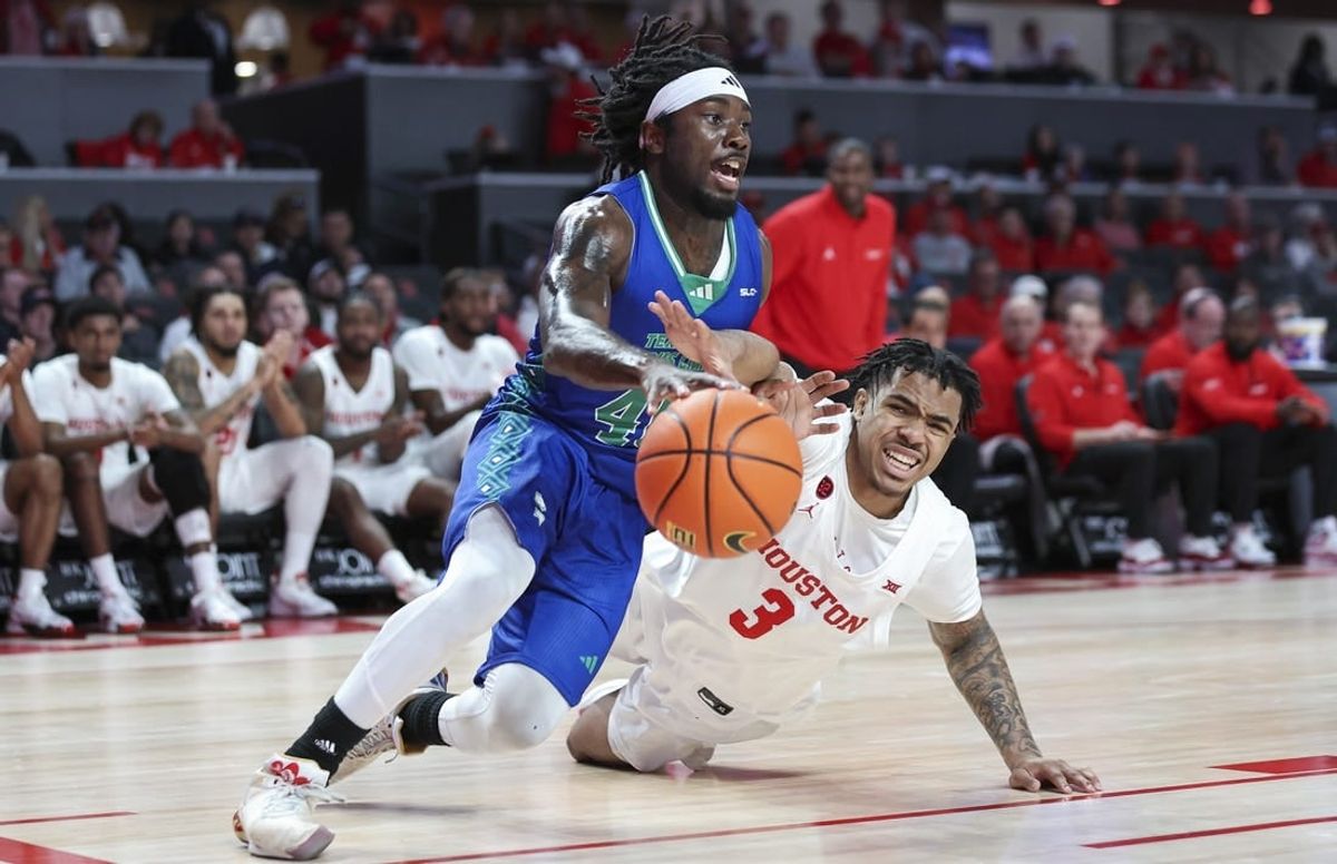 Nov 11, 2023; Houston, Texas, USA; Texas A&M-CC Islanders guard Lance-Amir Paul (40) drives with the ball as Houston Cougars guard Ramon Walker Jr. (3) defends during the first half at Fertitta Center.
