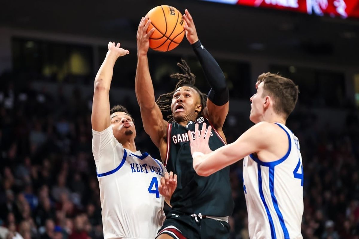 Jan 23, 2024; Columbia, South Carolina, USA; South Carolina Gamecocks guard Meechie Johnson (5) drives between Kentucky Wildcats forward Tre Mitchell (4) and forward Zvonimir Ivisic (44) in the first half at Colonial Life Arena.
