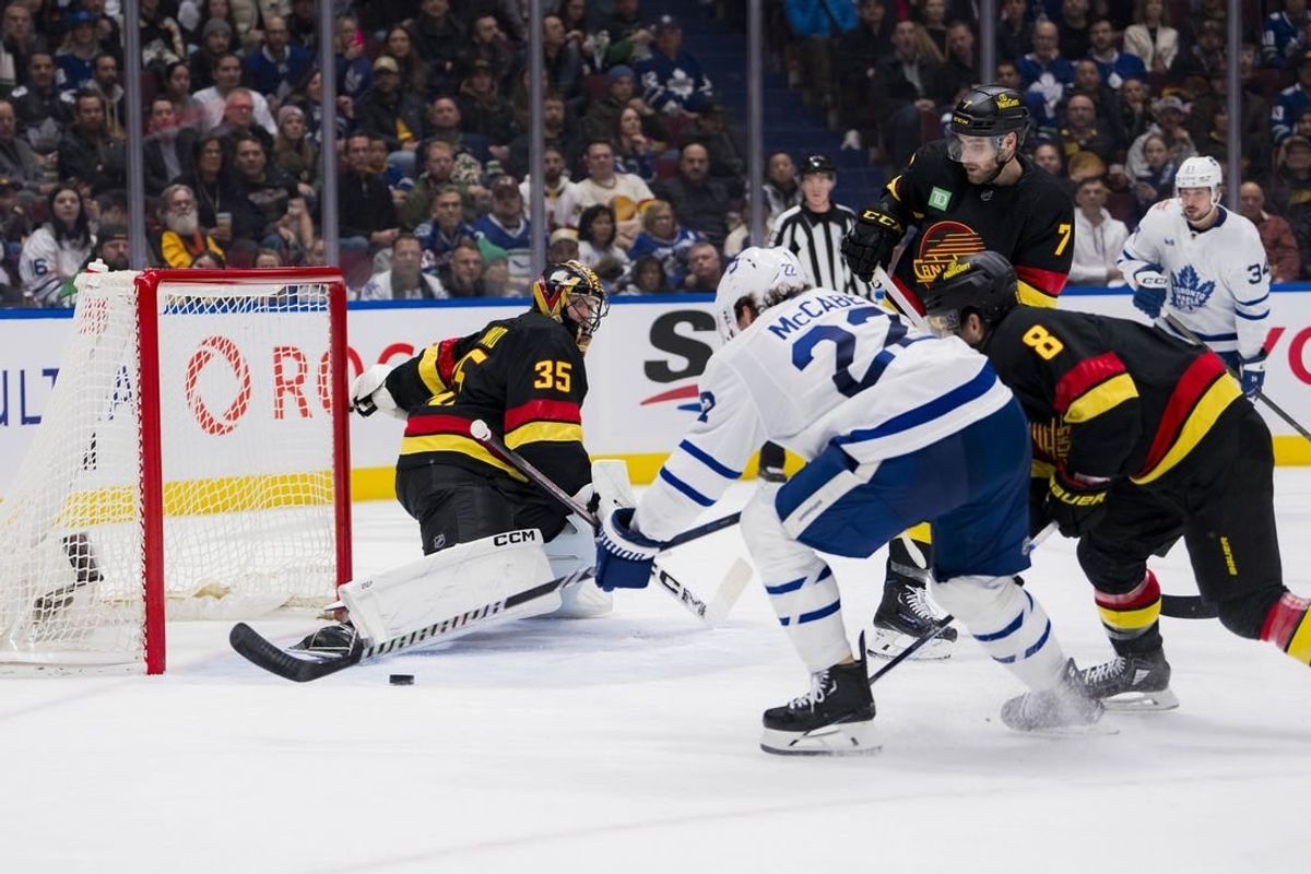 Jan 20, 2024; Vancouver, British Columbia, CAN; Toronto Maple Leafs defenseman Jake McCabe (22) scores on Vancouver Canucks goalie Thatcher Demko (35) in the second period at Rogers Arena.