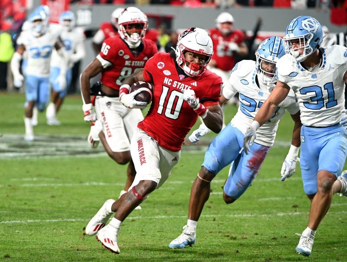 Nov 25, 2023; Raleigh, North Carolina, USA; North Carolina State Wolfpack receiver KC Concepcion (10) runs after a catch against North Carolina Tar Heels defensive back Will Hardy (31) during the first half at Carter-Finley Stadium.