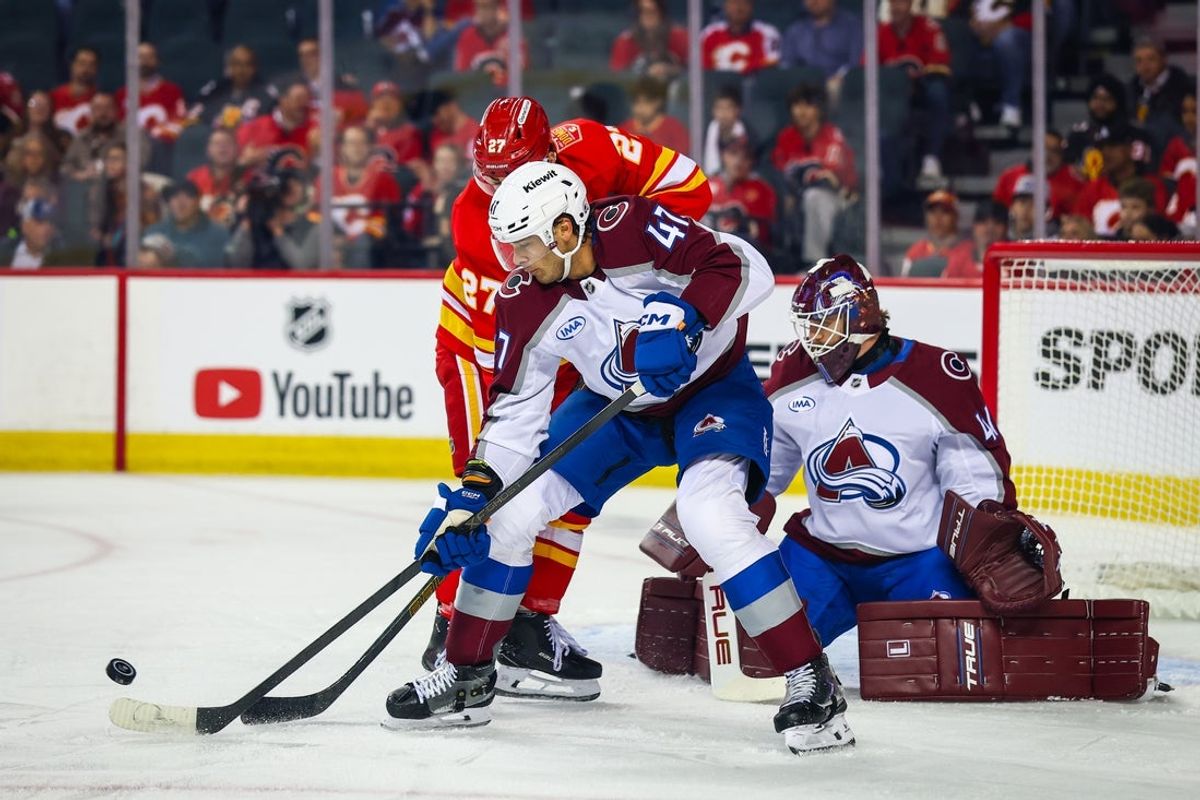 Oct 8, 2026; Calgary, Alberta, CAN; Colorado Avalanche defenseman Noah Juulsen (47) and Calgary Flames right wing Matt Coronato (27) battle for the puck in front of Colorado Avalanche goaltender Scott Wedgewood (41) during the first period at Scotiabank Saddledome. Mandatory Credit: Sergei Belski-Imagn Images