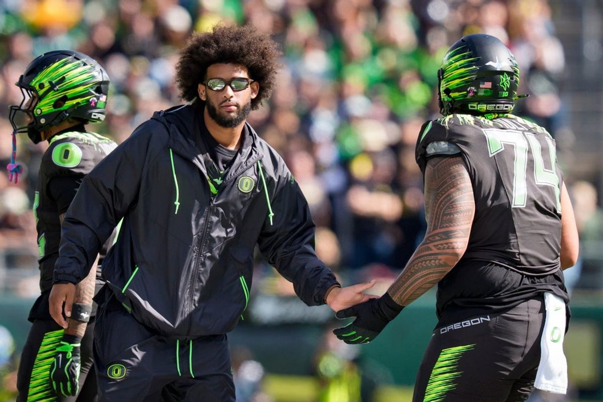 Oregon quarterback Dante Moore, left, greets Oregon offensive lineman Dave Iuli as the Oregon Ducks host the UCLA Bruins on Oct. 10, 2026, at Autzen Stadium in Eugene, Oregon.