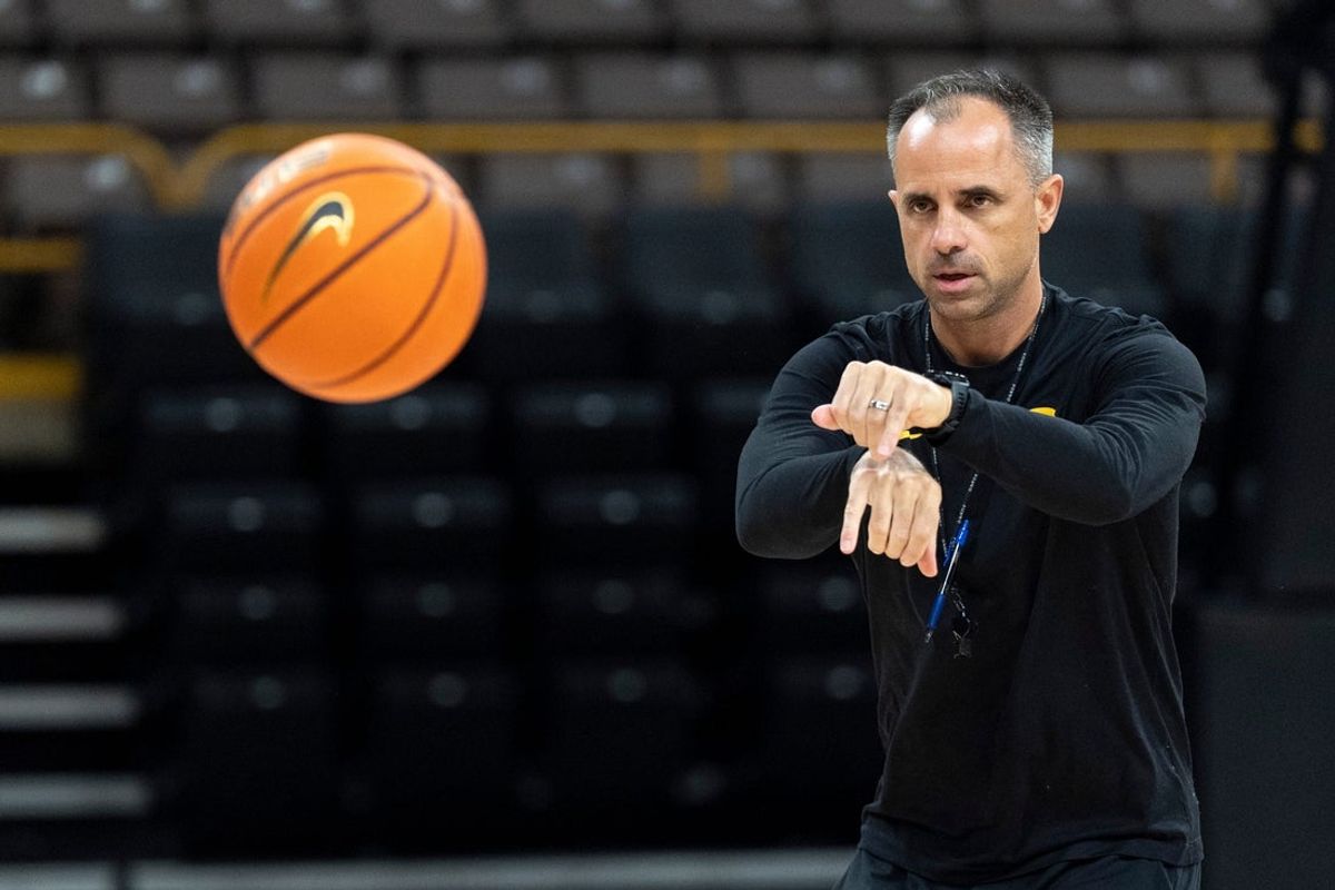 Iowa head coach Ben McCollum passes the ball Oct. 12, 2026 during an Iowa men’s basketball open practice at Carver-Hawkeye Arena in Iowa City, Iowa.