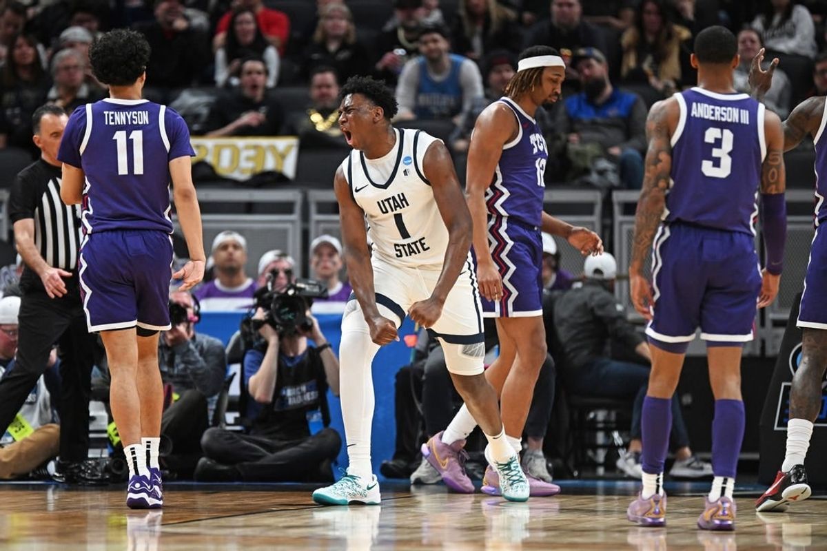 Mar 22, 2024; Indianapolis, IN, USA; Utah State Aggies forward Great Osobor (1) reacts after a play during the first half against the TCU Horned Frogs in the first round of the 2024 NCAA Tournament at Gainbridge FieldHouse.